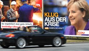 Ein Auto fährt an Wahlplakaten, die den SPD-Spitzenkandidaten Frank-Walter Steinmeier neben Bundeskanzlerin Angela Merkel (CDU) zeigen, vorbei.