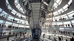 Photo: visitors walking around the dome of the Reichtags Building and reading information boards