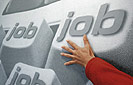Bild: Eine Hand greift nach Tasten mit der Beschriftung JOB