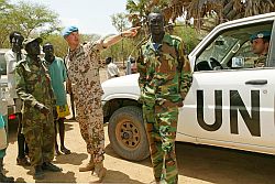 Deutsche Militärbeobachter stehen mit Afrikanern vor einem UN-Geländewagen