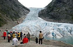 Touristen stehen vor dem Gletscher Jostedalsbreen