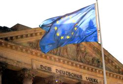 European and German flags in front of the Reichstag building