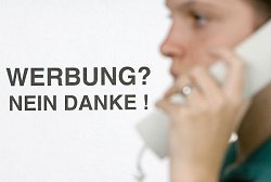 Eine Frau hält einen Telefonhörer in der Hand, daneben der Schriftzug: Werbung? Nein danke!