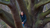 Frau Behm sitzt auf einem Baum