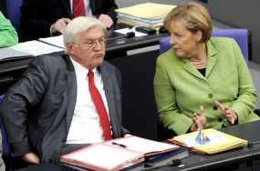 Steinmeier und Merkel sitzen zusammen im Plenarsaal des Reichstagsgebudes.