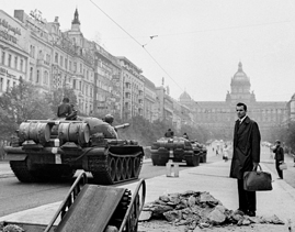 Panzer auf dem Prager Wenzelsplatz, davor ein Mann mit Aktentasche.