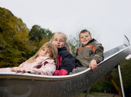 Drei Kinder auf einer Rutsche