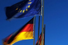 European and German flags in front of the Reichstag building