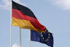The German flag fluttering in the wind next to the European flag
