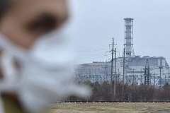 Mann mit Munschutz vor Reaktor in Tschenobyl