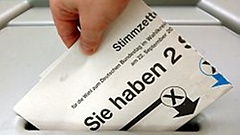 A ballot paper being cast into a ballot box