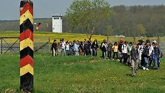 Schüler passieren einen ehemaligen Grenzpfahl