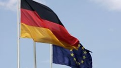 The German flag fluttering in the wind next to the European flag